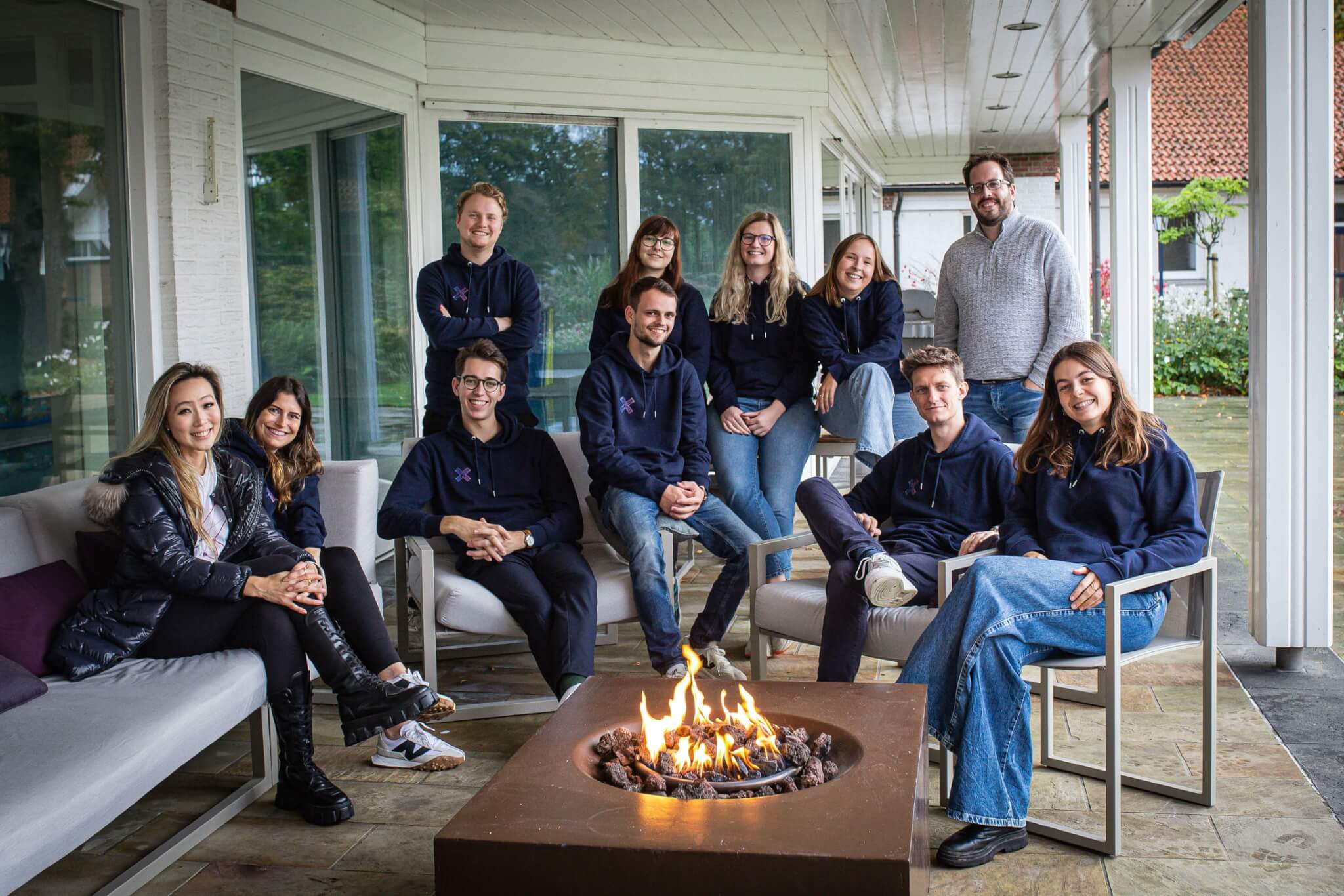 the STRAREX marketing agency team sitting around a campfire